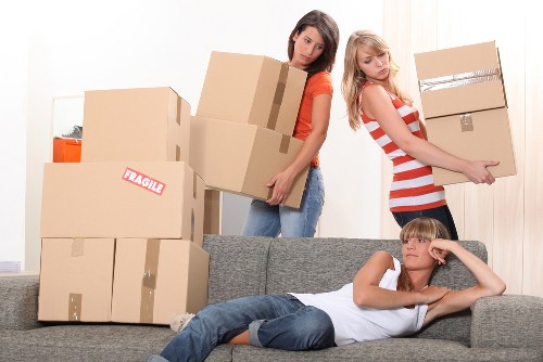 Movers navigating stairs in a Hampstead apartment building
