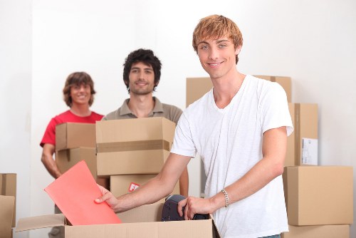 Professional movers loading fragile items safely for transport in Hampstead